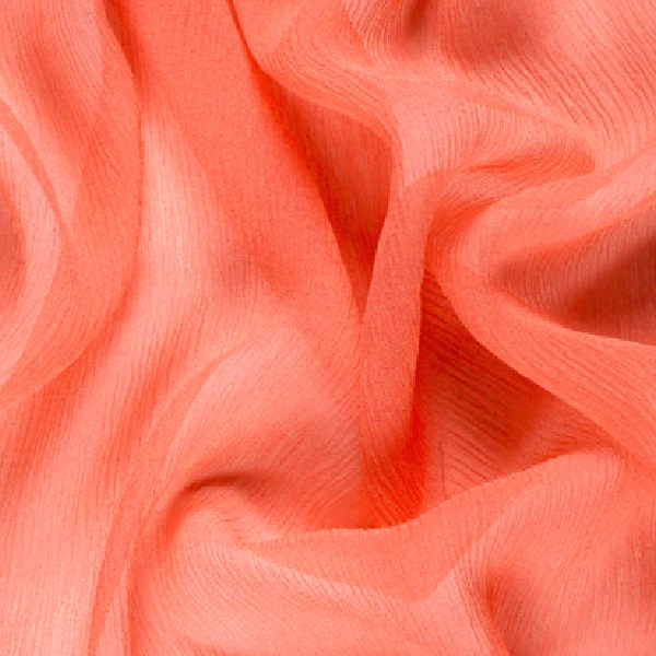 Close-up of a draped, sheer coral-colored fabric