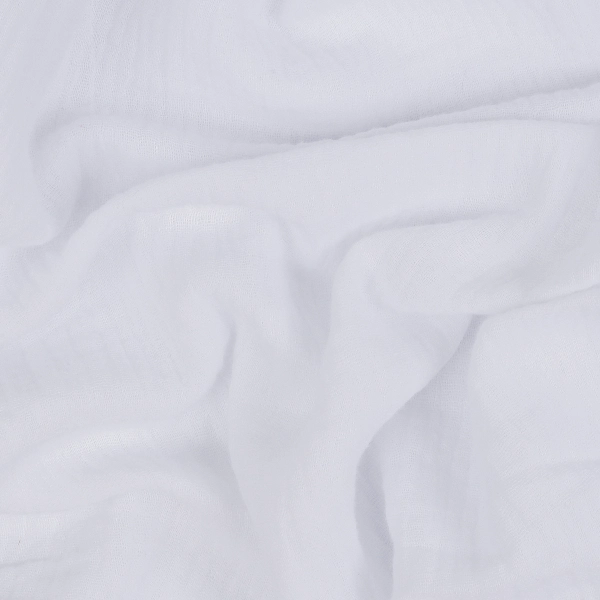 Close-up of a draped, sheer white fabric with subtle folds and a light texture.