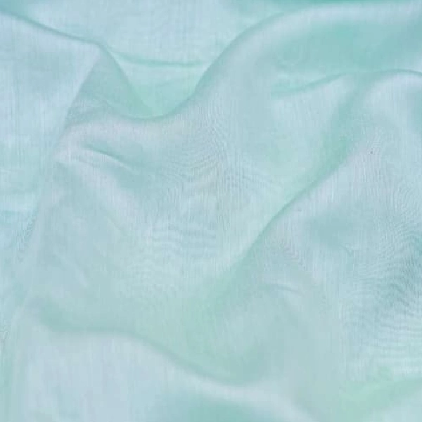 Sheer light green curtain fabric.