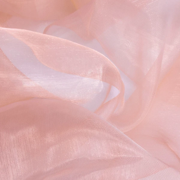 Sheer, soft pink fabric with luminous folds and visible translucence, demonstrating how light passes through its delicate weave.