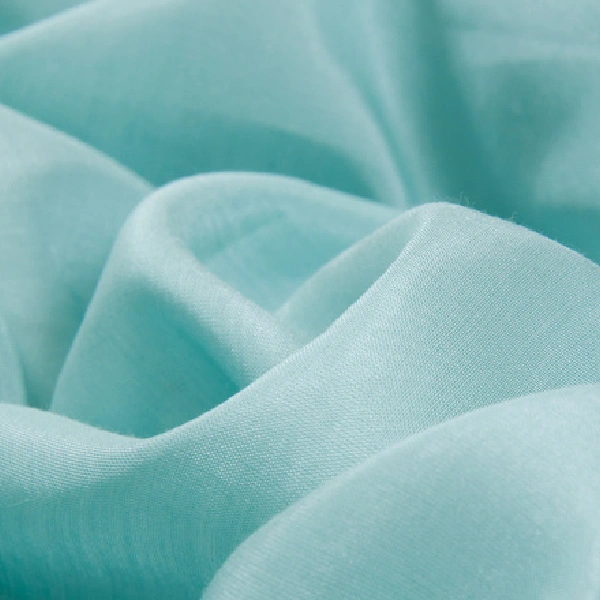 Softly draped light blue fabric.