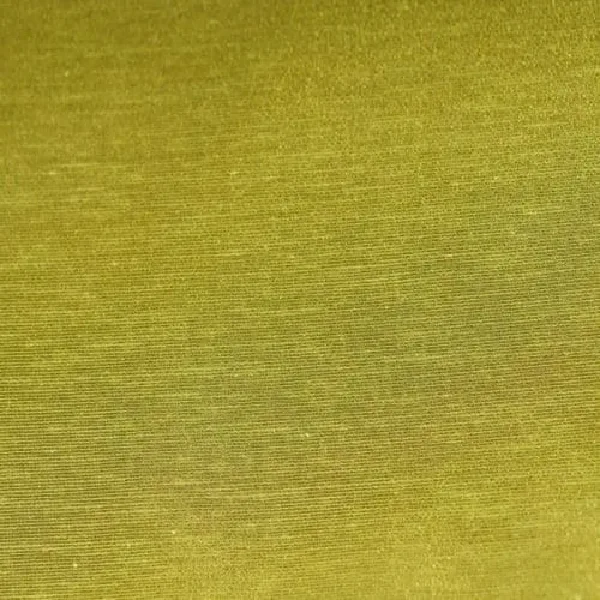 A close-up of green curtain fabric with a subtle horizontal ribbing.