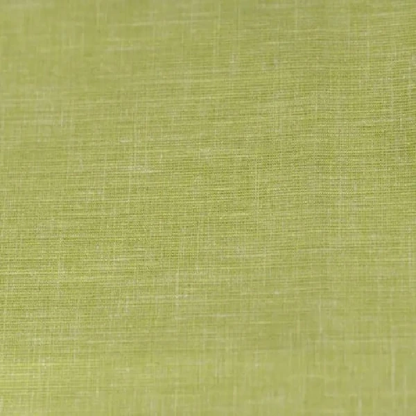 A close-up of green curtain fabric with a subtle woven texture.