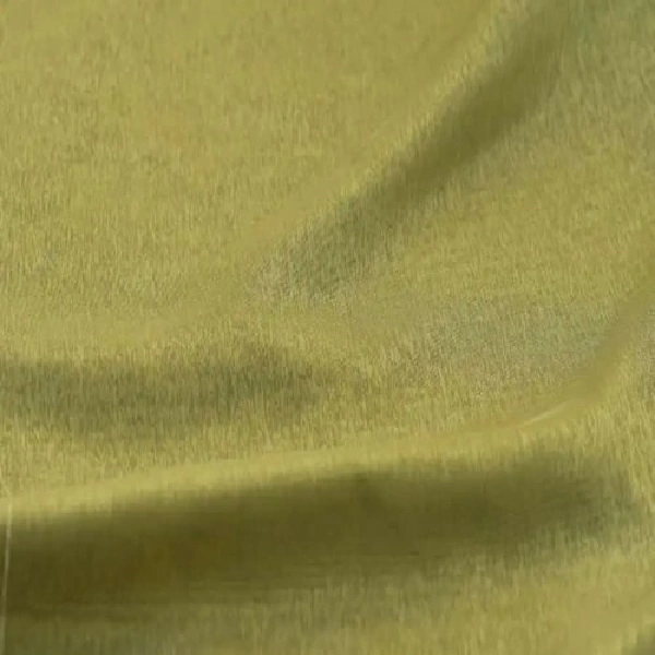 A close-up of soft, fuzzy green curtain fabric with folds.