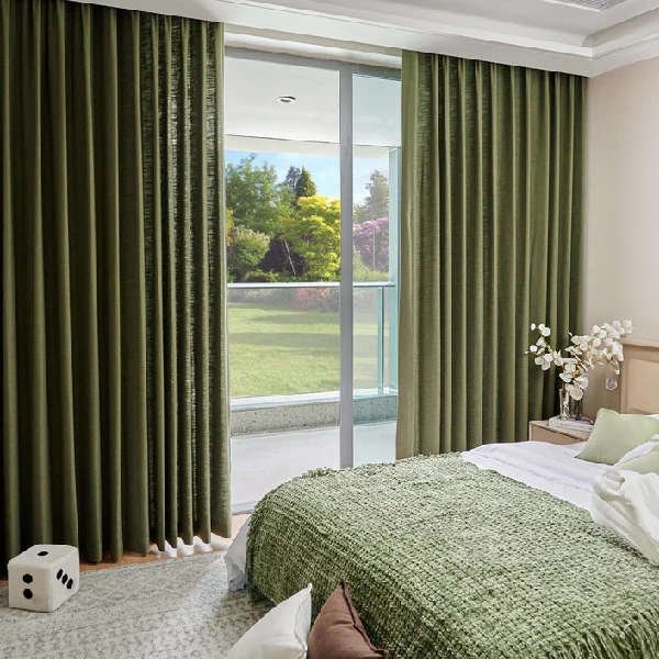 Olive green linen curtains in a bedroom with a large sliding glass
