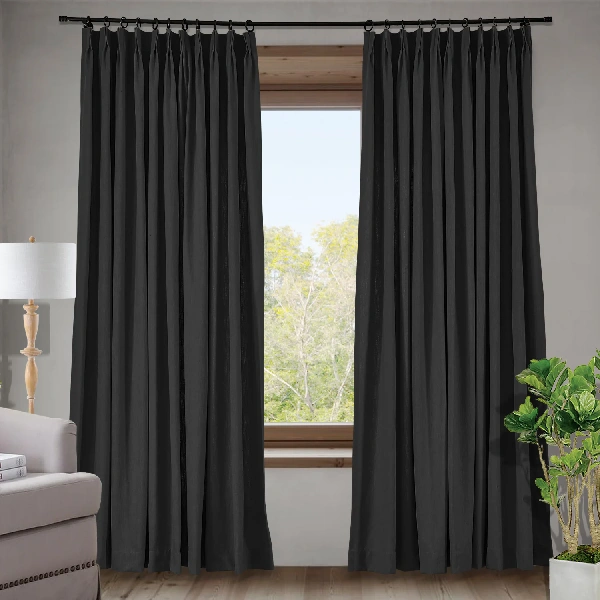 Pinch pleat curtains in a dark gray or charcoal color.