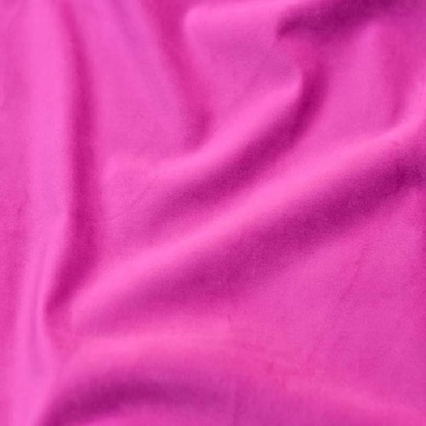 a vibrant fuchsia pink fabric, likely a curtain, with soft folds