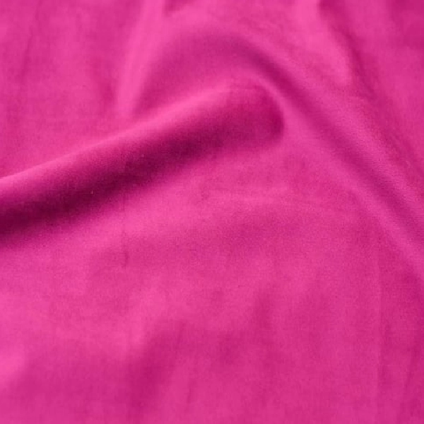 a vibrant fuchsia pink fabric, likely a curtain, with soft folds.